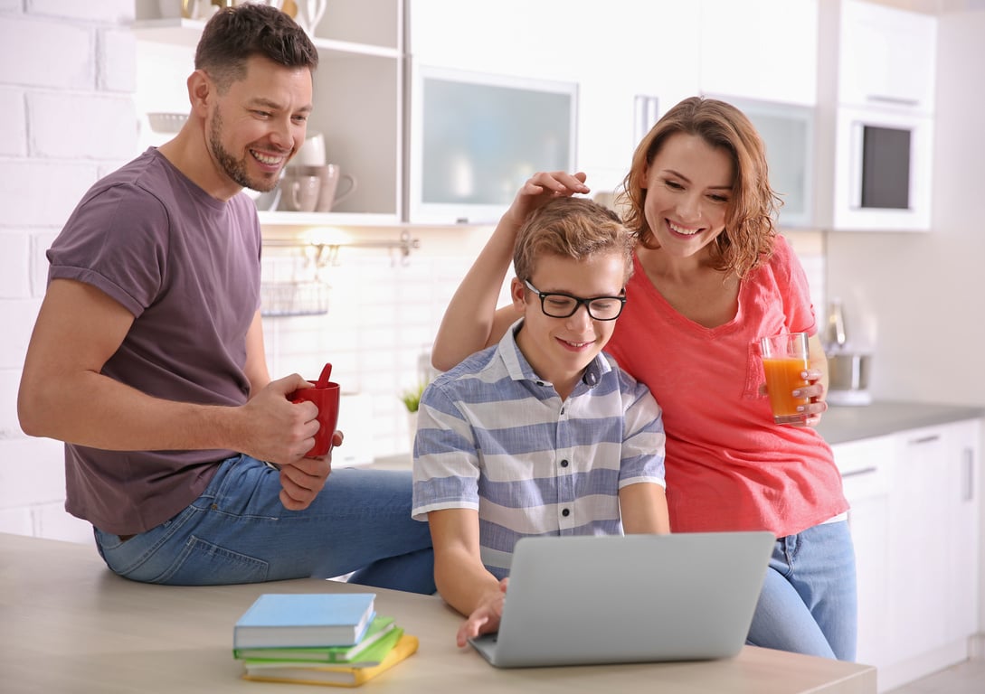 Teenager with Parents Doing Homework at Home